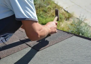 close-up-of-roofer-installing-shingle-tiles